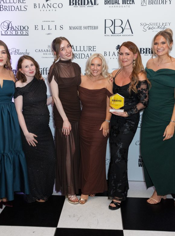 You are precious bridal team of 9 stylists holding the team of the year award at the bridal buyer awards 2025