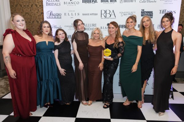 You are precious bridal team of 9 stylists holding the team of the year award at the bridal buyer awards 2025